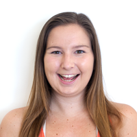 Photo of a woman smiling with her mouth open.