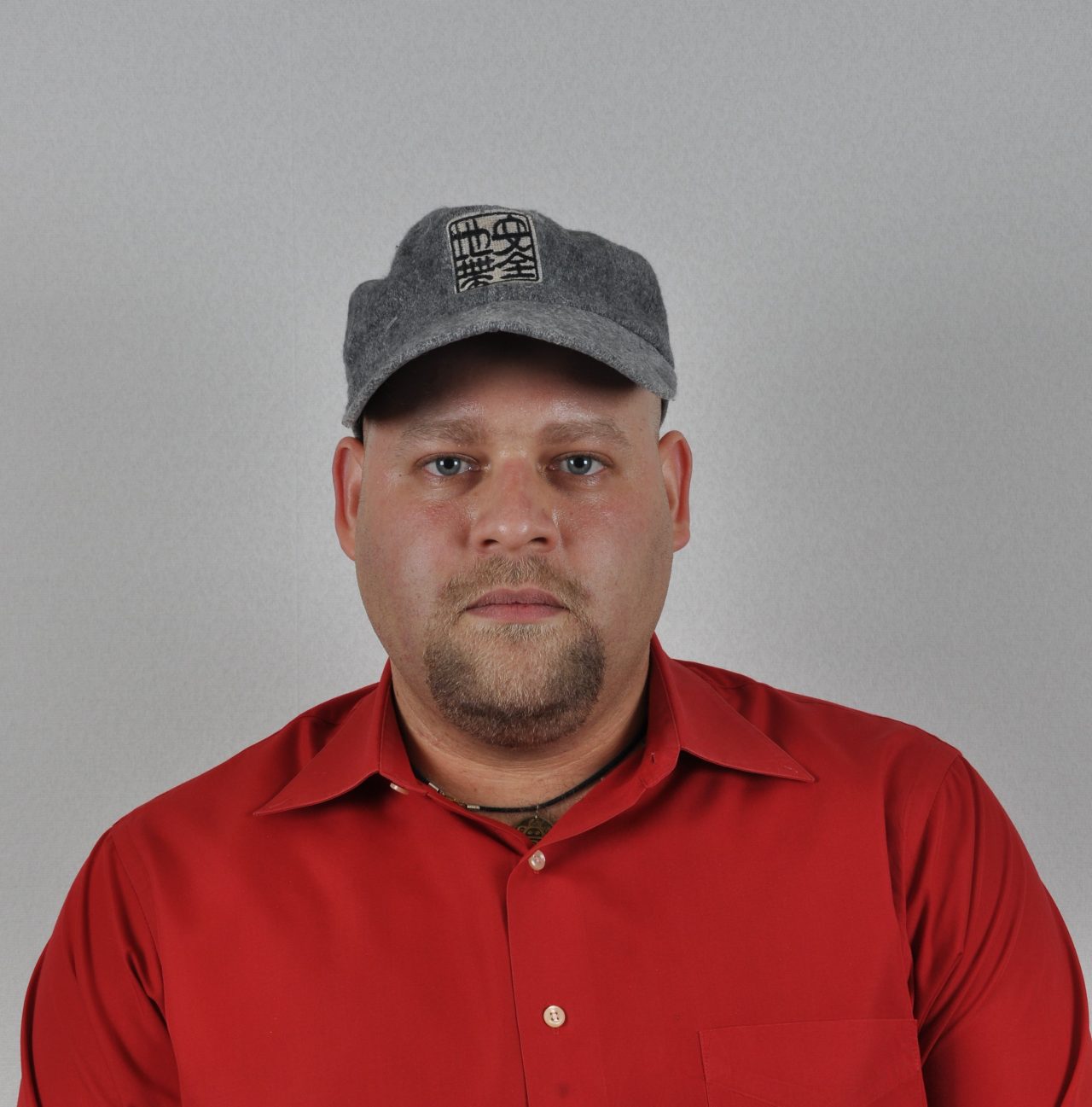 Photo of a man wearing a hat.
